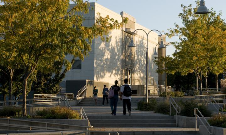 Students walk by a campus building