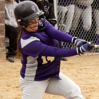 Softball player swinging bat