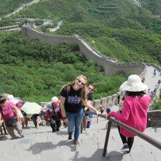 Young woman climbs the Great Wall in China