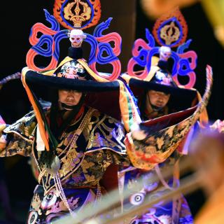 Tibetan monks perform a colorful dance