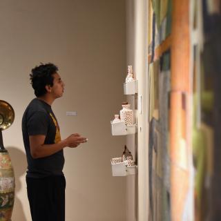 Student looking at artwork in Rosenthal Gallery