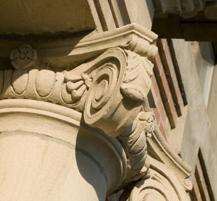 Scroll atop a building column