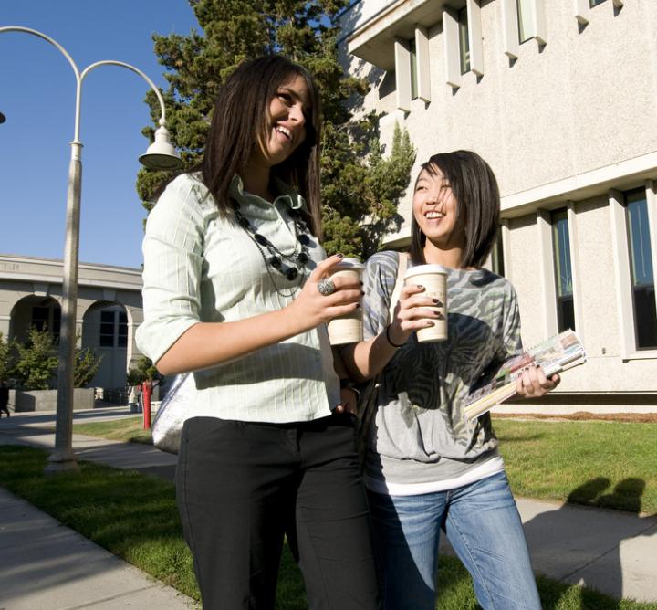 Two young women walking on campus