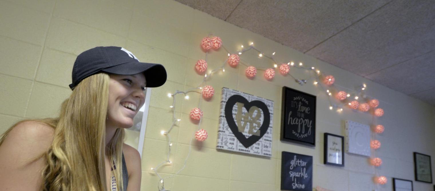 Smiling girl in new dorm room