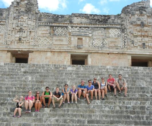 Students on the steps of ancient ruins