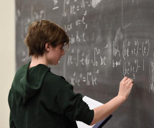 Student working at chalkboard