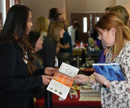 A student and employer review a document at the career fair