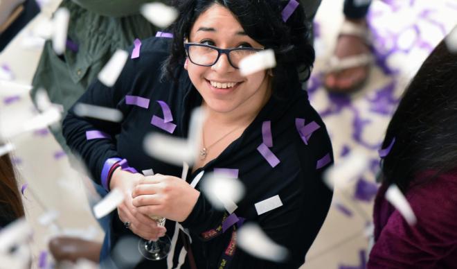 Student looking up as confetti falls