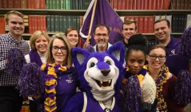 Yote mascot with people in the library