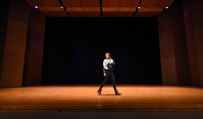 A contestant of the 2017 Miss C of I walks across the Jewett Auditorium stage