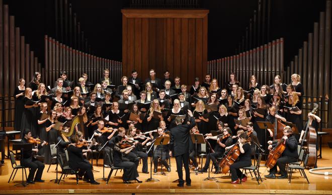 C of I Chorale and Sinfonia perform on stage in Jewett Auditorium