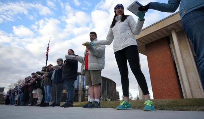 Students, staff, faculty and alumni of The College of Idaho pass books to the Cruzen-Murray Library.