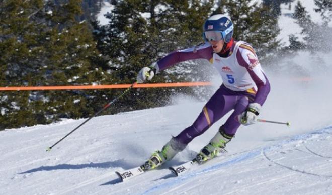 Lucas Underkoffler skis down a mountain as part of the C of I men's skiing team.