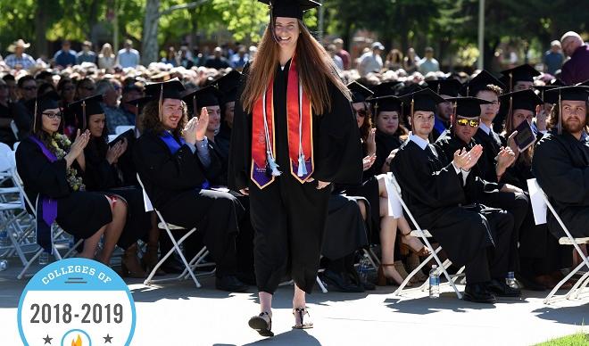 A C of I student at the 2018 Commencement featuring a 2018-2019 "Colleges of Distinction" badge.
