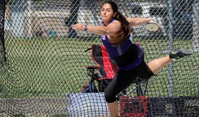 Claire Otero prepares a discus throw during track-and-field competition.