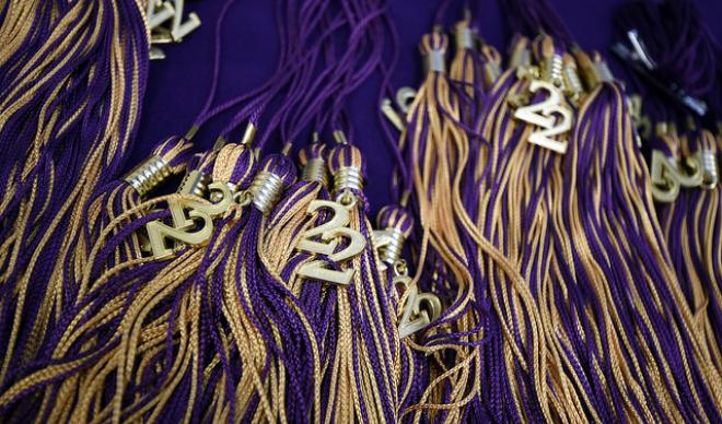 Graduation tassels for the Class of 2022 stack against each other.