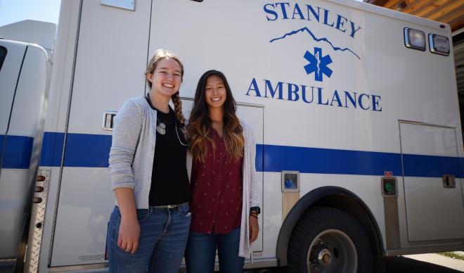 Isabela Lete and Hailey Woods pose in front of an ambulance at the Salmon River Emergency Clinic in Stanley, Idaho.