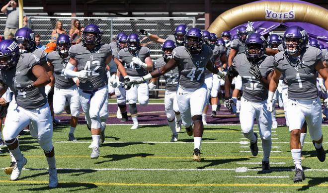 The C of I football team storms the field for the home opener against Montana Tech on Sept. 1, 2018.
