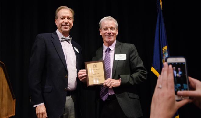 Co-President Jim Everett accepts award