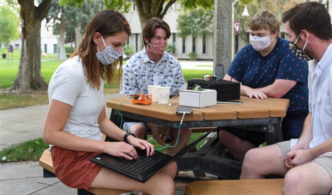Masked students working in Quad