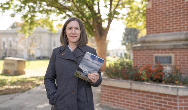 Jennie Daniels holding her book
