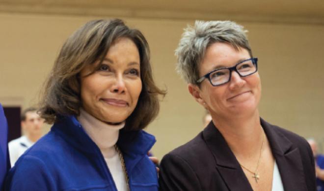 Vice President of Athletics Reagan Rossi (right) honors Elgin Baylor and his widow Elaine (left), a College Board of Trustee member, prior to tipoff at a home basketball game.