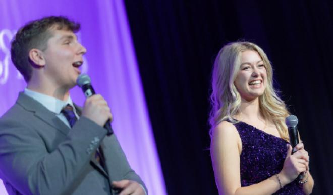 Students Joey Calzaretta and Amara Davidson on stage at the gala 