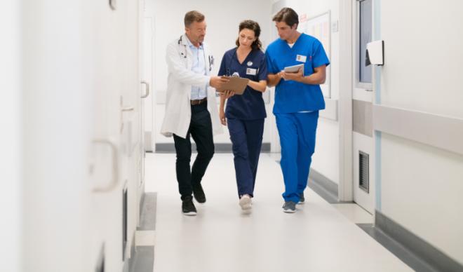 Group of PAs walking in a hallway 