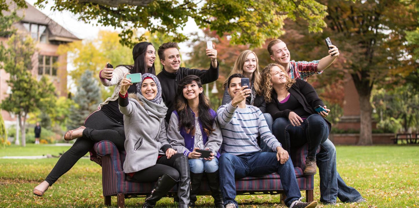 Students taking selfies with phones