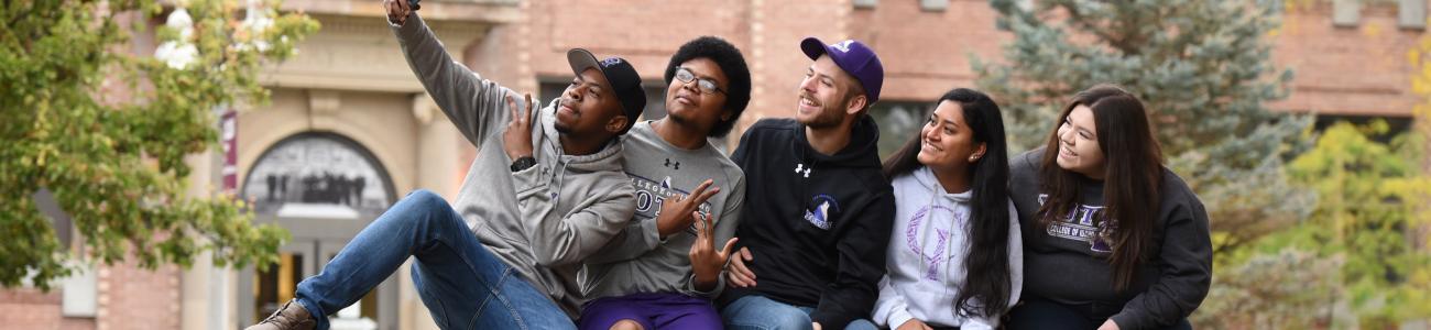 Student sitting on a rock in the Quad